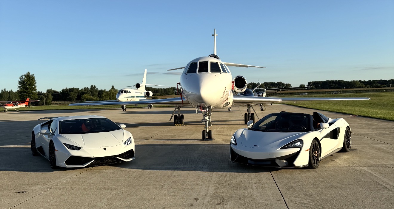 Exotic supercars with a private jet on the tarmac